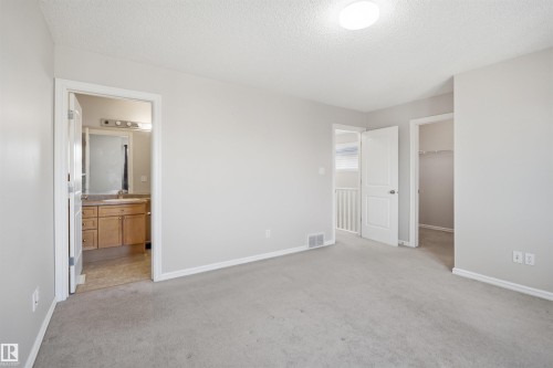 Carpeted room with light gray walls, a flush-mount ceiling light, and white trim - 1124 37A Avenue, Edmonton, AB - Indoor Photo Showing Other Room