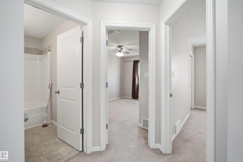 Neutral-toned hallway featuring light grey walls and carpeted flooring - 1124 37A Avenue, Edmonton, AB - Indoor Photo Showing Other Room