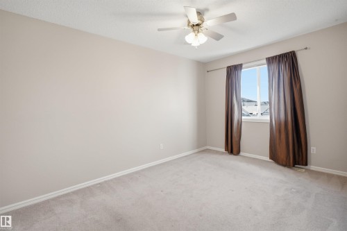 Neutral-toned walls and light-colored carpeting create a versatile interior space - 1124 37A Avenue, Edmonton, AB - Indoor Photo Showing Other Room
