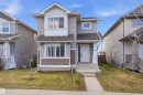 Two-story residential exterior featuring mixed siding, a pitched roof, and a prominent bay window - 1124 37A Avenue, Edmonton, AB  - Outdoor With Facade 