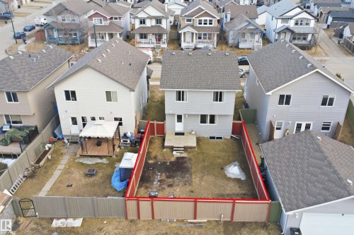 Rear exterior featuring a grey siding finish and shingled roof - 1124 37A Avenue, Edmonton, AB - Outdoor