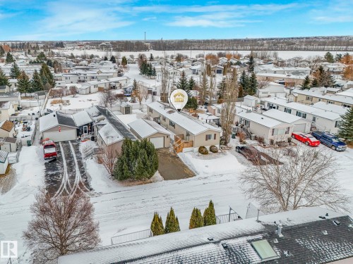 Aerial perspective showcasing a residential community with snow-covered grounds - 151 3400 48 Street, Stony Plain, AB - Outdoor With View