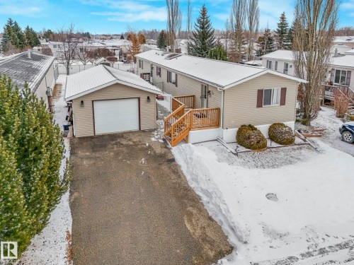 Detached garage with a white overhead door and exterior lighting - 151 3400 48 Street, Stony Plain, AB - Outdoor