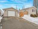 Detached garage with horizontal siding, a white panel garage door, and accent lighting - 151 3400 48 Street, Stony Plain, AB  - Outdoor With Exterior 