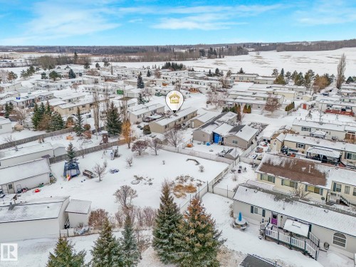 Residential neighborhood featuring multiple single-story homes with pitched roofs and fenced backyards - 151 3400 48 Street, Stony Plain, AB - Outdoor With View