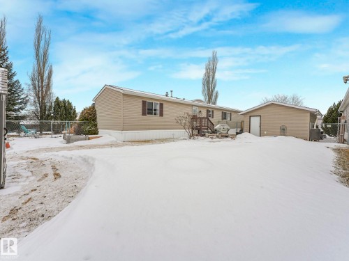 Rear exterior with tan siding and a brown-stained wooden deck - 151 3400 48 Street, Stony Plain, AB - Outdoor