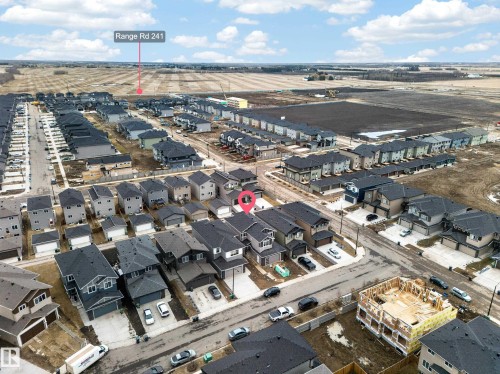 Aerial view showcasing a residential development with numerous single-family homes and townhomes, featuring a mix of architectural styles - 4005 39 Street, Beaumont, AB - Outdoor With View