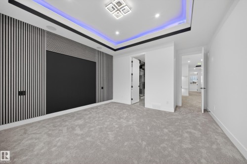 Recessed lighting in a tray ceiling with accent lighting - 4005 39 Street, Beaumont, AB - Indoor Photo Showing Other Room