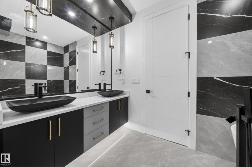 Dual vanity featuring matte black vessel sinks and faucets - 4005 39 Street, Beaumont, AB - Indoor