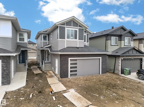 Contemporary facade featuring multiple gables and varied siding textures - 4005 39 Street, Beaumont, AB - Outdoor With Facade