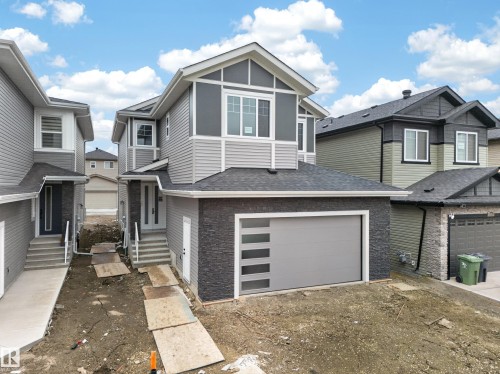 Contemporary two-story exterior with multi-toned siding and dark stone accenting - 4005 39 Street, Beaumont, AB - Outdoor With Facade