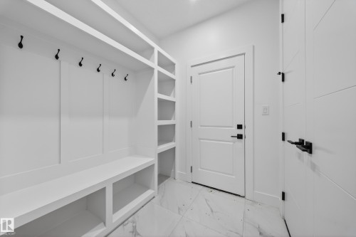 Built-in storage solutions featuring a bench, open shelving, and wall hooks - 4005 39 Street, Beaumont, AB - Indoor