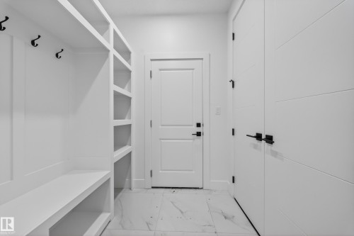 Built-in mudroom storage featuring bench seating, integrated shelving, and black hooks - 4005 39 Street, Beaumont, AB - Indoor