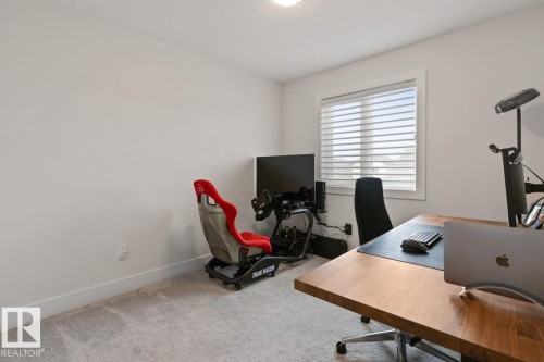 Carpeted room with a large window featuring horizontal blinds - 6023 180 Avenue, Edmonton, AB - Indoor Photo Showing Office