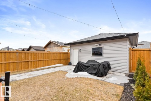 Detached garage with horizontal siding, a side entrance, and a window - 6023 180 Avenue, Edmonton, AB - Outdoor With Exterior