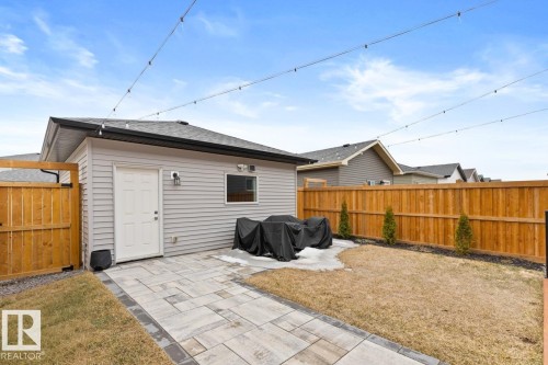 Detached garage with horizontal siding, a side entry door, and an exterior light fixture - 6023 180 Avenue, Edmonton, AB - Outdoor With Exterior