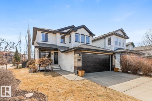 Two-story residence featuring light-colored siding with dark trim accents - 2178 Haddow Drive, Edmonton, AB - Outdoor