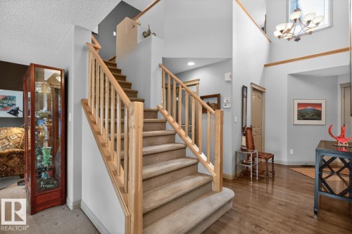 Grand foyer featuring a two-story ceiling, a chandelier, and wood-finish flooring - 2178 Haddow Drive, Edmonton, AB - Indoor Photo Showing Other Room