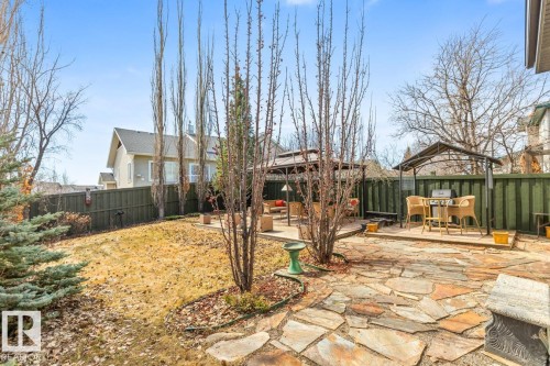 Expansive backyard with a flagstone patio, sloped lawn, and mature trees - 2178 Haddow Drive, Edmonton, AB - Outdoor