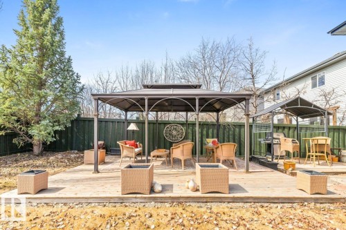 Spacious backyard featuring two distinct covered patio areas on a wood-finish deck - 2178 Haddow Drive, Edmonton, AB - Outdoor With Deck Patio Veranda