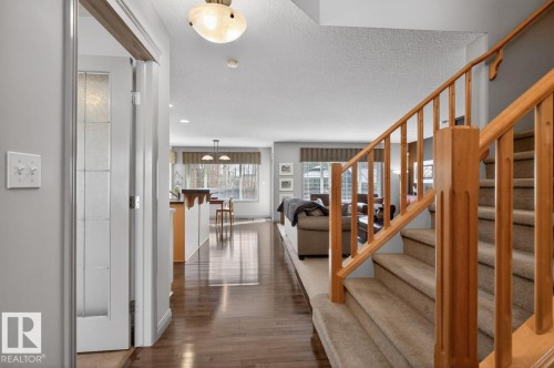 Hardwood-finish flooring extending from the entryway into the living area - 2178 Haddow Drive, Edmonton, AB - Indoor Photo Showing Other Room