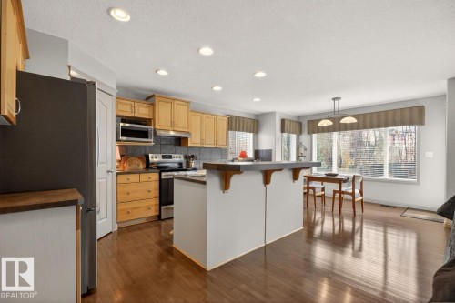 Kitchen featuring wood-finish flooring, recessed lighting, and light wood cabinetry - 2178 Haddow Drive, Edmonton, AB - Indoor Photo Showing Kitchen