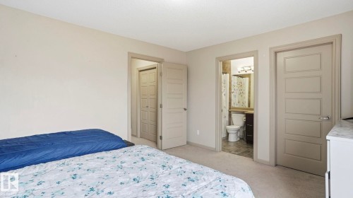 Bedroom featuring light neutral wall paint, carpet flooring, and modern five-panel interior doors - 8210 180 Avenue Nw, Edmonton, AB - Indoor Photo Showing Bedroom