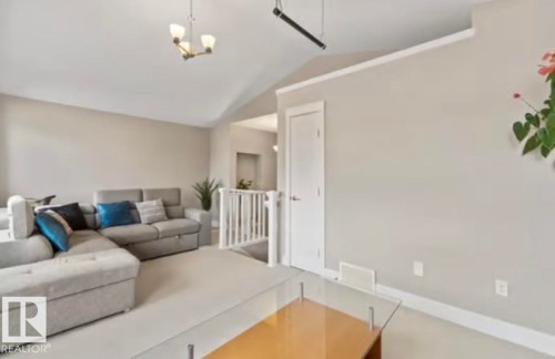 Vaulted ceiling featuring a brass-finish chandelier - 1944 67 Street, Edmonton, AB - Indoor