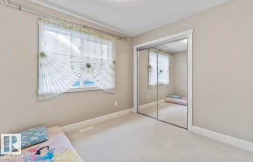 Carpeted room with neutral wall tones and a double window - 1944 67 Street, Edmonton, AB - Indoor