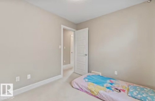 Spacious room featuring neutral tone walls, white trim, and light-colored carpeting - 1944 67 Street, Edmonton, AB - Indoor Photo Showing Bedroom
