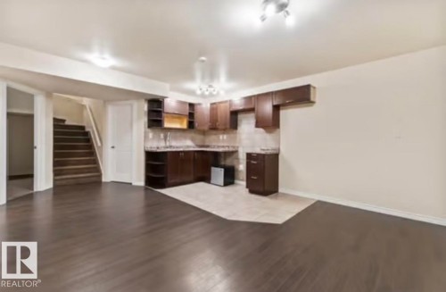 Lower level featuring dark wood-finish flooring and light-toned walls - 1944 67 Street, Edmonton, AB - Indoor Photo Showing Kitchen