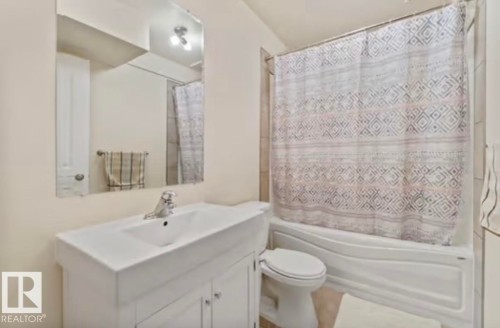 White vanity with integrated sink and chrome faucet - 1944 67 Street, Edmonton, AB - Indoor Photo Showing Bathroom