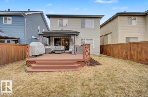 Ground-level deck with multi-level stairs and decorative lattice railing - 1944 67 Street, Edmonton, AB - Outdoor With Deck Patio Veranda With Exterior