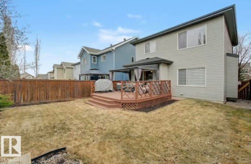 Rear exterior featuring an expansive wood deck with lattice railing, an integrated gazebo, and privacy screens - 1944 67 Street, Edmonton, AB - Outdoor With Deck Patio Veranda With Exterior
