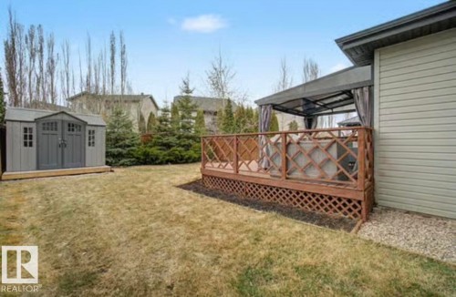 Expansive backyard featuring a wood deck with lattice detailing and an integrated gazebo structure - 1944 67 Street, Edmonton, AB - Outdoor With Deck Patio Veranda With Exterior