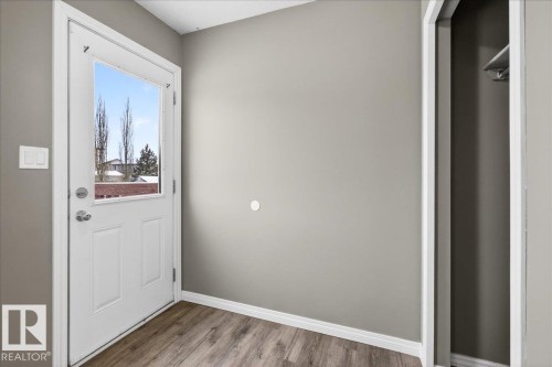 Entryway featuring baseboards and wood finished floors - 150 Acacia Circle, Leduc, AB - Indoor Photo Showing Other Room