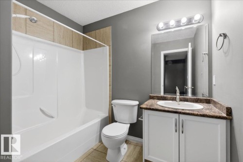 Bathroom with vanity, bathtub / shower combination, and a textured ceiling - 150 Acacia Circle, Leduc, AB - Indoor Photo Showing Bathroom