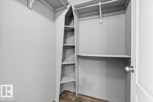 Walk in closet with light wood-style flooring - 150 Acacia Circle, Leduc, AB - Indoor With Storage