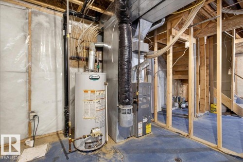 Utility room with gas water heater and heating unit - 150 Acacia Circle, Leduc, AB - Indoor Photo Showing Basement