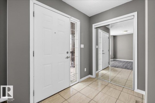 Entryway featuring a textured ceiling and light tile patterned flooring - 150 Acacia Circle, Leduc, AB - Indoor Photo Showing Other Room