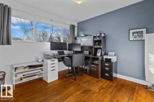 Room featuring wood-finish flooring, white baseboards, and a large multi-pane window - 10756 133 Street, Edmonton, AB - Indoor Photo Showing Office