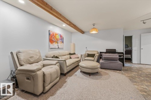 Spacious carpeted room featuring recessed lighting and exposed ceiling beams - 10756 133 Street, Edmonton, AB - Indoor