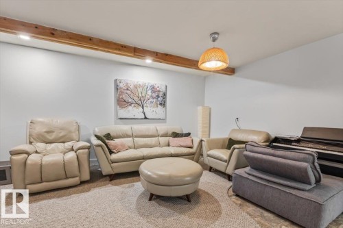 Lower-level living space featuring recessed lighting, exposed wood ceiling beams, and a textured area rug - 10756 133 Street, Edmonton, AB - Indoor