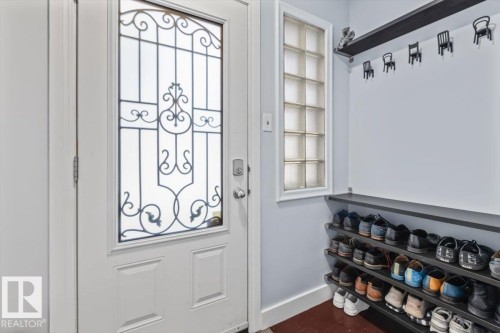 Entryway featuring a white door with decorative wrought iron detailing and frosted glass - 10756 133 Street, Edmonton, AB - Indoor Photo Showing Other Room