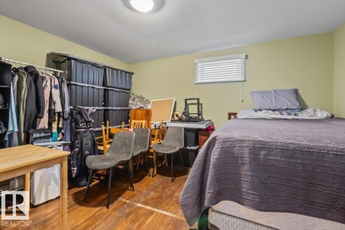 Room featuring wood-finish flooring, a single window with blinds, and light-toned wall paint - 10756 133 Street, Edmonton, AB - Indoor Photo Showing Bedroom