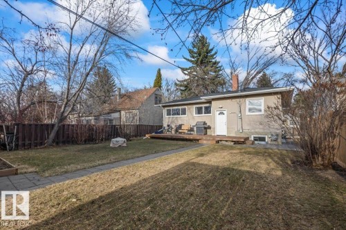 Expansive backyard featuring a manicured lawn, paved walkway, and privacy fencing - 10756 133 Street, Edmonton, AB - Outdoor