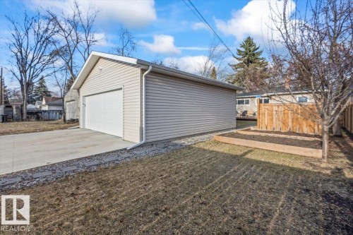 Detached garage with light-toned siding and a white garage door - 10756 133 Street, Edmonton, AB - Outdoor