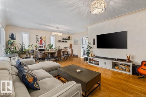 Hardwood flooring throughout the living and dining areas - 10756 133 Street, Edmonton, AB - Indoor Photo Showing Living Room