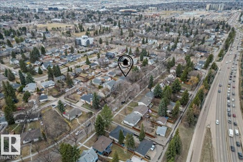 Aerial perspective showcasing a residential neighborhood with mature trees and a multi-lane thoroughfare - 10756 133 Street, Edmonton, AB - Outdoor With View