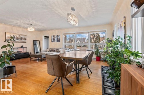 Open-concept living and dining area featuring wood-finish flooring, multiple large windows, and recessed lighting - 10756 133 Street, Edmonton, AB - Indoor Photo Showing Dining Room